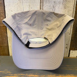 back of beige cap on a wooden surface
