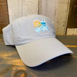 light grey cap with a beach chair and sun design on a wooden surface