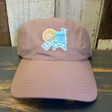 dusty rose cap with a beach chair and sun design on a wooden surface