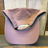 dusty rose baseball cap with colorful Muy Hermosa logo on a wooden surface