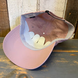 dusty rose cap with a beach chair and sun design on a wooden surface