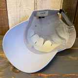 Light grey cap with a visible brand label on a wooden surface