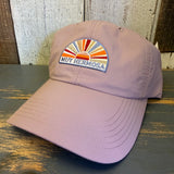 dusty rose baseball cap with colorful Muy Hermosa logo on a wooden surface