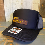 High-crown trucker hat with curved brim and adjustable snapback, made of mesh and fabric in Hermosa Ave design.