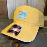 Yellow cotton dad hat with Hermosa Beach lifeguard tower design shown on a wooden surface. Ideal for sun protection.