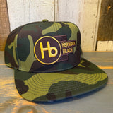 Camo 6-panel cotton hat with a yellow front logo, designed for everyday casual wear.