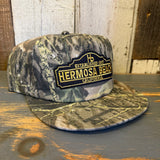 Camo 5-panel surf hat in green and brown, made of durable fabric, suitable for outdoor wear.