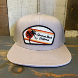 Faded bone 6-panel trucker hat with retro sunset patch; mesh back and curved brim for casual, everyday wear.