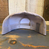 Inside-out retro sunset trucker hat with six panels on a rustic wood surface; mesh and fabric construction.