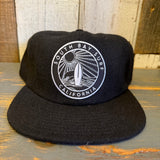Black 6-panel strapback hat with surf-themed patch, made of premium material, ideal for everyday casual wear.
