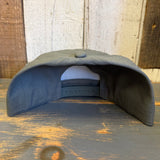 Cypress green 5-panel cotton hat with Grand Teton National Park 1929 patch shown upside down on wood surface.