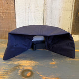 Two-tone nylon cap displayed upside down on a wooden surface; features UFO BIGFOOT CONSPIRACY text.