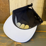 White and black cap on a wooden surface