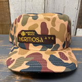 Camo 5-panel workhorse hat with sun patch and snapback closure; suitable for casual outdoor wear.