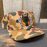 Camo 5-panel workhorse hat made of fabric, displayed on a wooden surface.