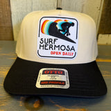 Black and natural 5-panel cap with front patch featuring surfer graphic and Open Daily text. Suitable for everyday wear.