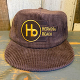 Java brown corduroy field trip hat with Hb logo and adjustable brass clasp. Casual, durable headwear for everyday use.