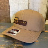 Wheat brown five-panel cotton cap, labeled PIER AVE, rests on a rustic wooden table.