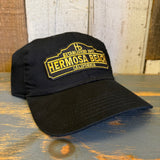 Black 6-panel dad hat with low profile and a yellow patch, suitable for casual wear.