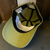 Desert green cotton dad hat turned upside down, showing visible labels. For casual, everyday wear.