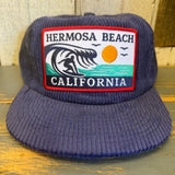 Navy corduroy field trip hat with surfer patch, vintage workwear style; suitable for outdoor or casual use.