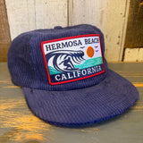 Navy corduroy hat with wave, sun, and bird patch; ideal for casual wear.