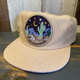 Eggshell corduroy field trip hat with a desert scene patch. Suitable for outdoor use.