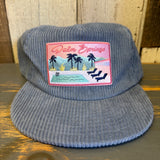 Slate blue corduroy hat with embroidered palm trees, chairs, and pool design. Casual and suitable for sunny weather.