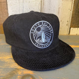 Black corduroy hat with a patch, unstructured and relaxed fit; ideal for casual wear.