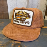 Camel corduroy field trip hat with embroidered patch showing a van, mountains, and trees. Suitable for outdoor wear.