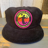 Black corduroy hat with a multicolored volleyball-themed patch on the front, suitable for casual wear.