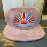 Hazy pink corduroy hat, ideal for beach days. Features soft texture and curved brim.