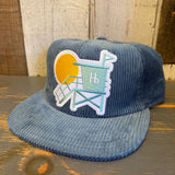 Slate blue corduroy lifeguard tower hat, ideal for beach activities like volleyball.