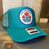 Jade green high crown trucker hat with mesh back and California poppy design.