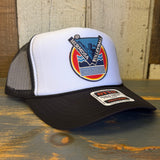 Black and white Hermosa Beach volleyball hat with embroidered text, displayed on a wooden surface.