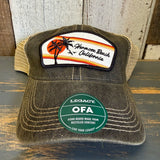 Mesh-back trucker cap with retro sunset design and green LEGACY OFA sticker, ideal for casual outdoor use.