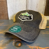 Gray six-panel trucker cap with mesh back rests on a wooden surface, suitable for outdoor wear.