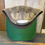 Navy and brown camo trucker cap with mesh panels, displayed on a wooden surface.