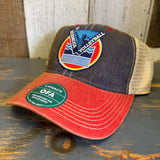 Red-brim trucker cap with snapback closure and low-profile fit, suitable for casual outdoor use.