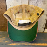 Black, cardinal, and khaki volleyball trucker cap made of mesh and fabric resting on a wooden surface.