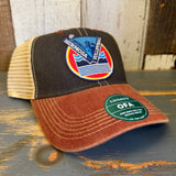 Black, cardinal, and khaki volleyball trucker cap with mesh back displayed on a wooden surface.