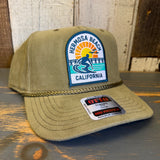 Olive green corduroy cap with a patch reading 1 to 3 FEET HIGH & RISING and a gold chain accent; casual outdoor wear.