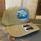 Olive green corduroy baseball cap on a wooden surface, designed for casual wear.