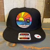 Black 5-panel snapback hat with a sunset patch, adjustable snap, and canvas material for casual wear.