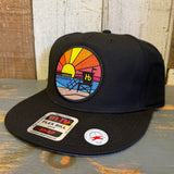 Black canvas 5 panel snapback hat with sunset patch and adjustable back, suitable for casual wear.