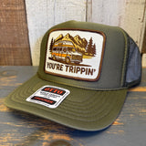 Olive high crown trucker hat with mesh panels, featuring a patch of camper, mountain, and trees on the front.