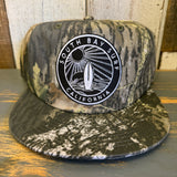 Surf camo 5-panel hat featuring a black patch and adjustable snapback; suitable for casual wear in South Bay, California.