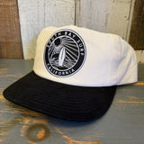 Black and natural two-tone snapback hat with a black patch, adjustable fit, suitable for everyday or surf-inspired wear.