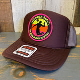 Brown mesh trucker hat with high crown and rectangular beach volleyball patch on the front.