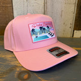 Pink 5-panel fabric cap featuring a Palm Springs California patch with palm trees, pool, and mountains.